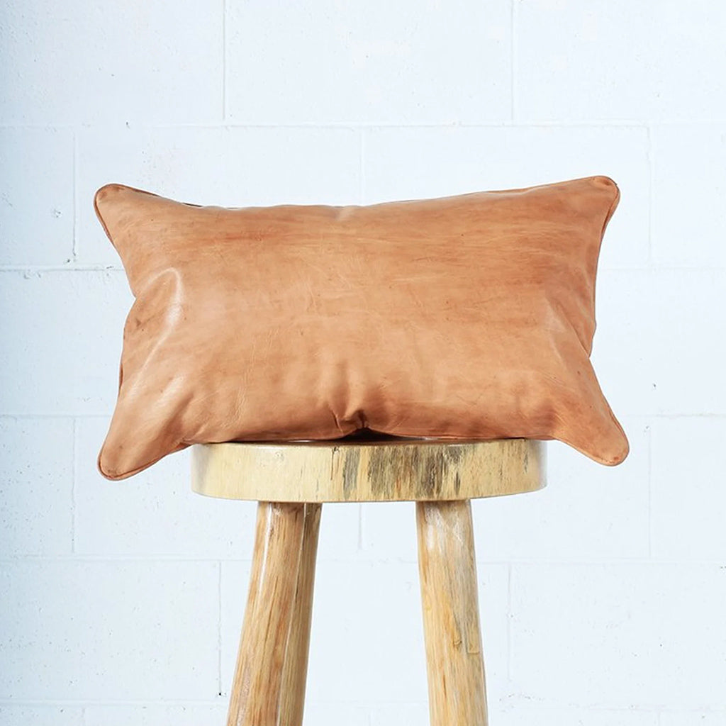 Moroccan Leather Pillow on top of a wood stool - Moroccan Interior