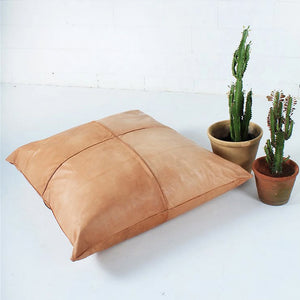 Moroccan Leather Pillow on the floor of a room - Moroccan Interior