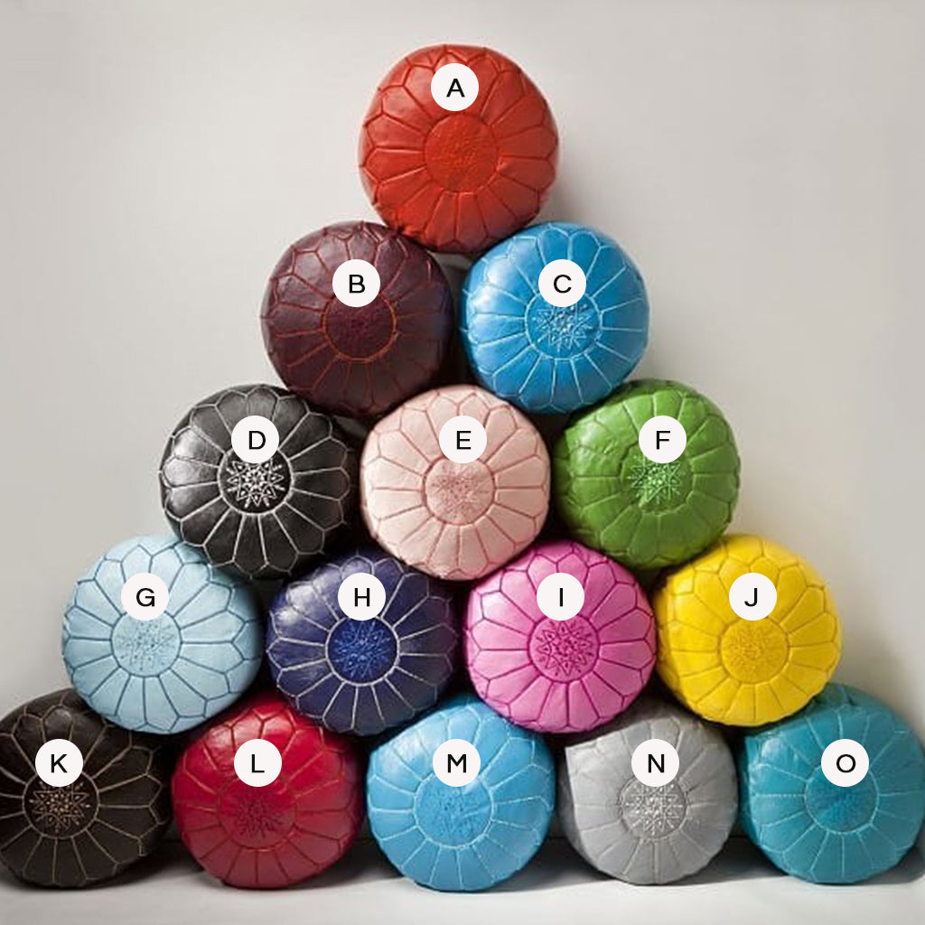 Moroccan Colorful Round Leather Pouf beside a gray wool in a room - Moroccan Interior