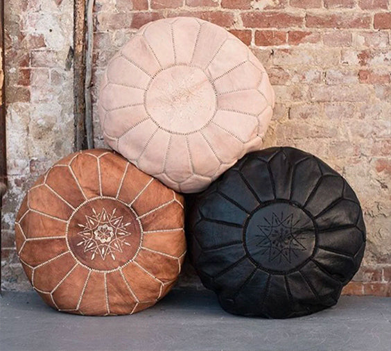 Set of three round leather pouf beside a brick wall - Moroccan Interior